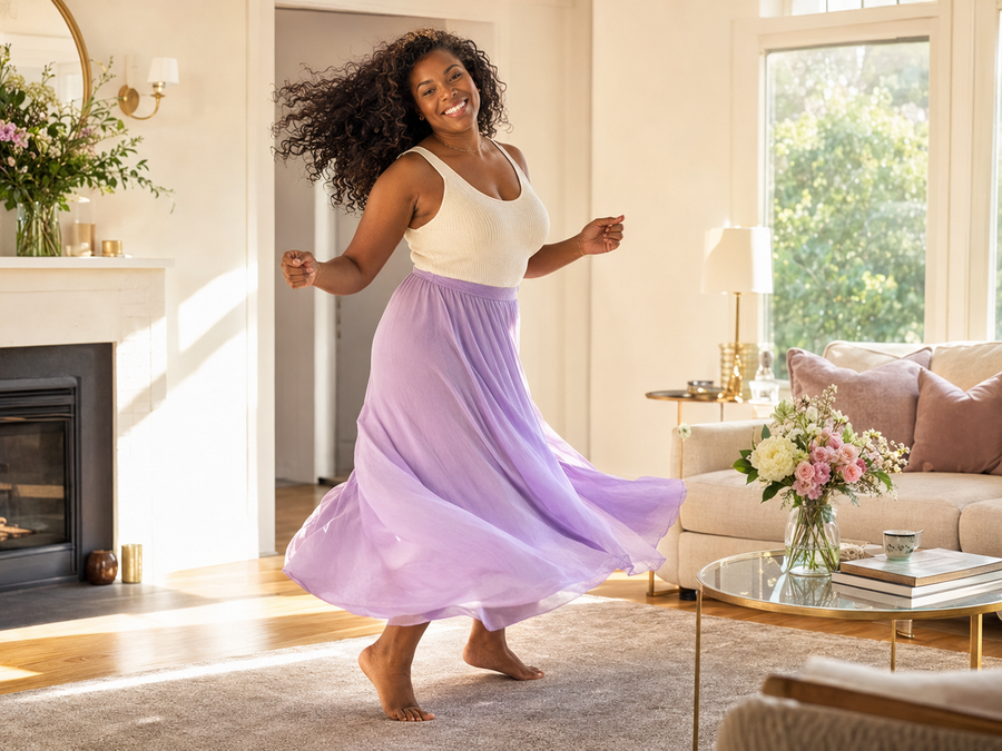 Joyful Black woman dancing freely at home
