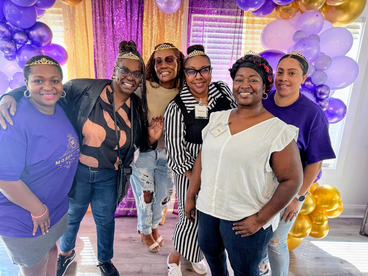 Women smiling together at a MoHERvation event